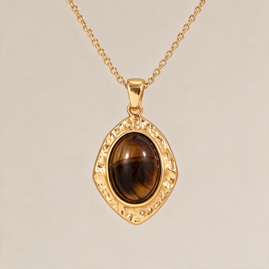 The Gemstone Pendant Necklace with the tiger's eye stone, on a plain ground.