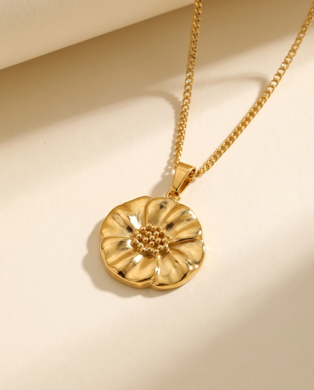 Poppy Flower Pendant Necklace in gold — a pendant on a chain in stainless steel with 18K gold plating.