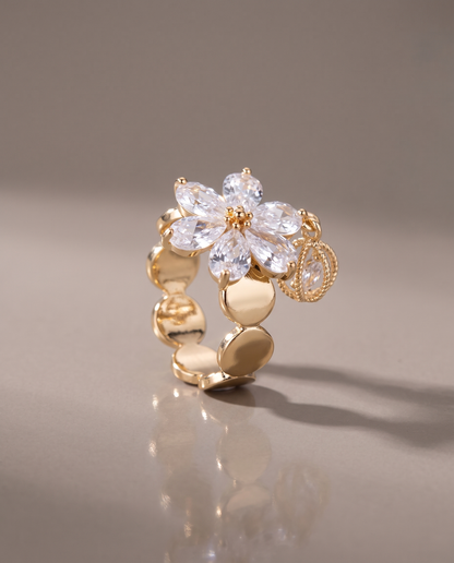The Bloom Ring in gold, on a plain ground.