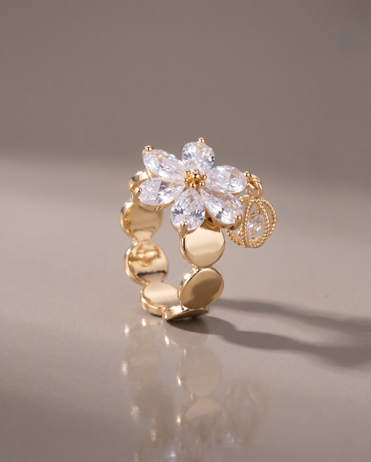 The Bloom Ring in gold, on a plain ground.