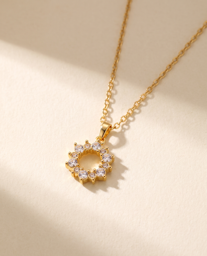 Geometric Ring Pendant Necklace in gold — stainless steel with 18K gold plating, on a plain ground.