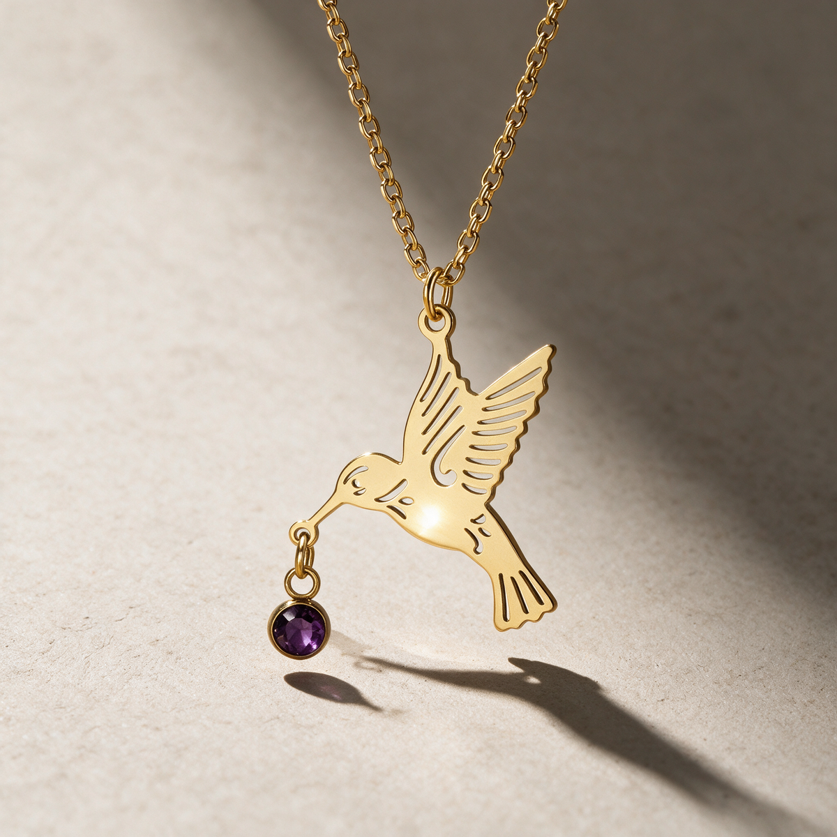 The Hummingbird Birthstone Necklace with the February birthstone.