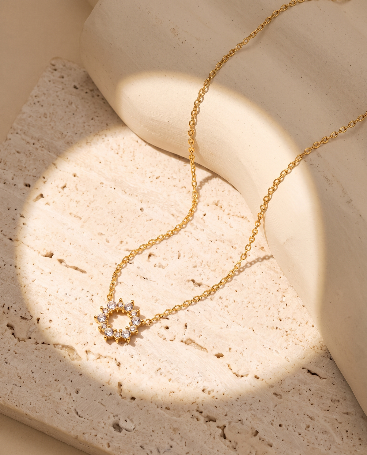Geometric Ring Pendant Necklace in gold — stainless steel with 18K gold plating, on a plain ground, view 2.