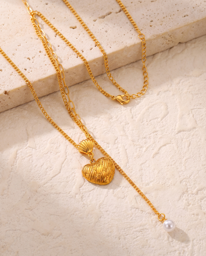 Love Pendant Tassel Necklace in gold — stainless steel with 18K gold plating, on a plain ground, view 4.