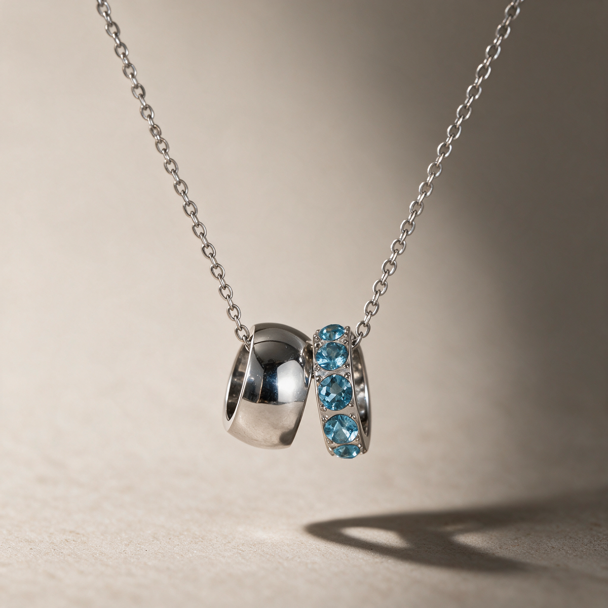 The Linked Birthstone Necklace in blue, styled in natural light, view 8.