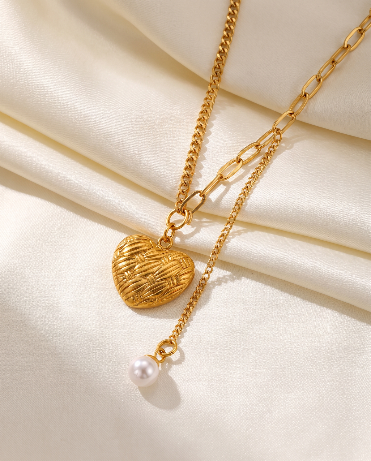 Love Pendant Tassel Necklace in gold — stainless steel with 18K gold plating, on a plain ground, view 5.