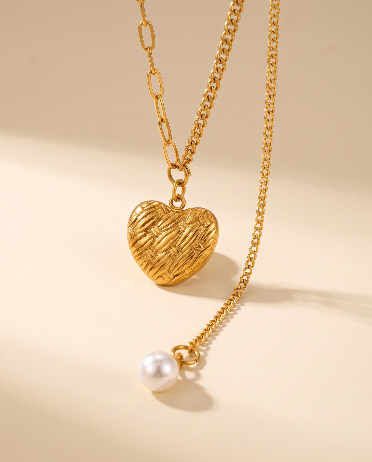 Love Pendant Tassel Necklace in gold — a pendant on a chain in stainless steel with 18K gold plating.